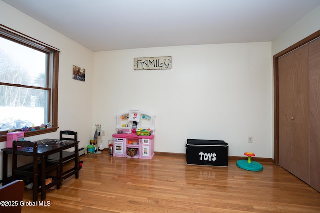 rec room with light hardwood / wood-style flooring