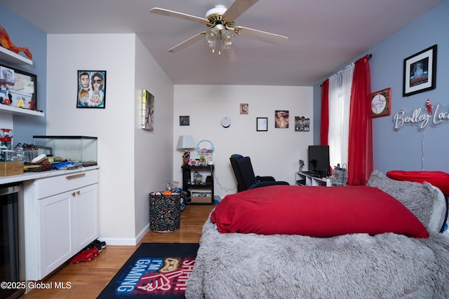 bedroom with hardwood / wood-style floors, wine cooler, and ceiling fan