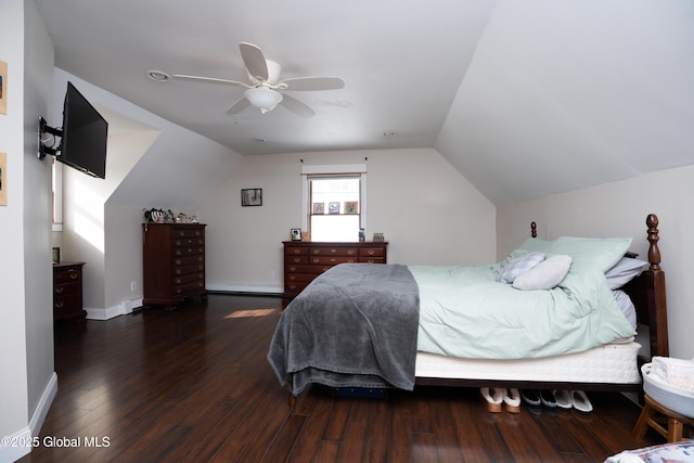 bedroom with dark hardwood / wood-style flooring, vaulted ceiling, and ceiling fan