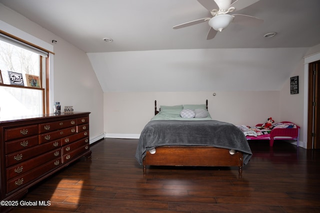 bedroom featuring dark hardwood / wood-style flooring, a baseboard radiator, ceiling fan, and vaulted ceiling