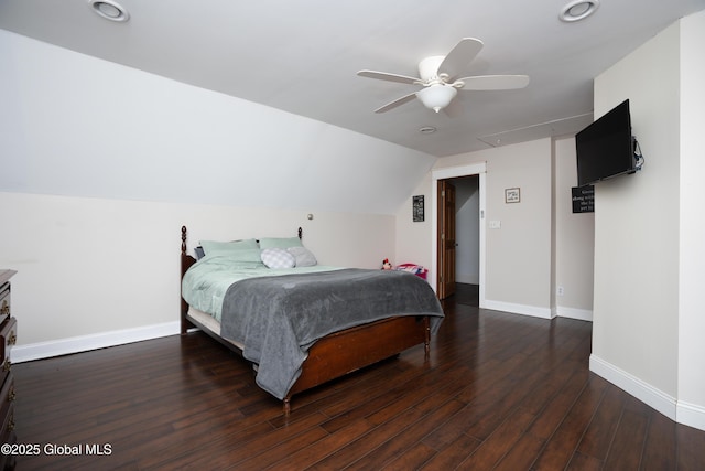 bedroom with dark hardwood / wood-style flooring, vaulted ceiling, and ceiling fan