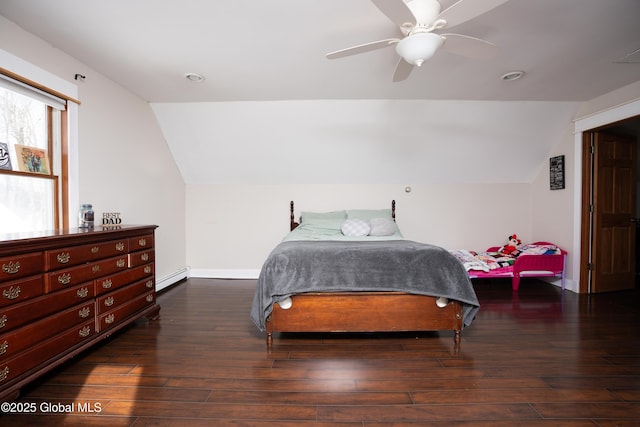 bedroom with dark hardwood / wood-style flooring, vaulted ceiling, ceiling fan, and baseboard heating