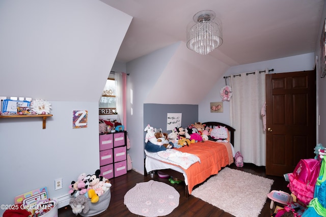 bedroom featuring dark hardwood / wood-style flooring, vaulted ceiling, and a chandelier