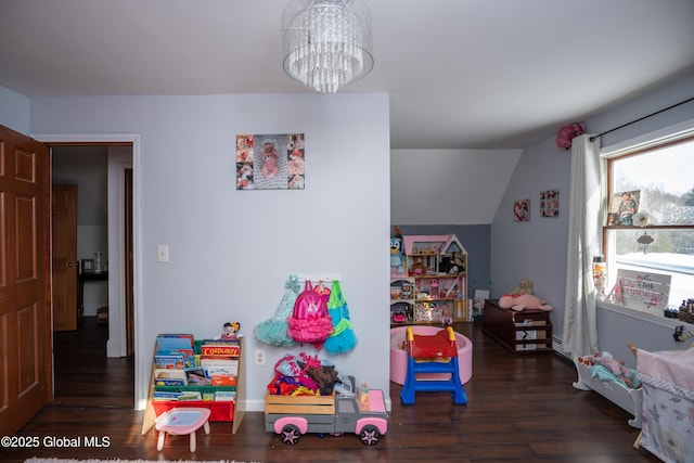 rec room featuring vaulted ceiling, dark hardwood / wood-style floors, and a chandelier