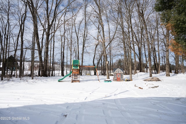 yard layered in snow with a playground