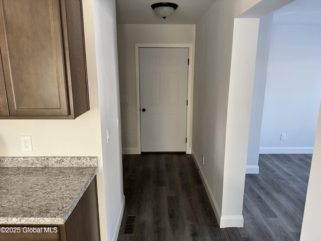 corridor featuring dark hardwood / wood-style floors