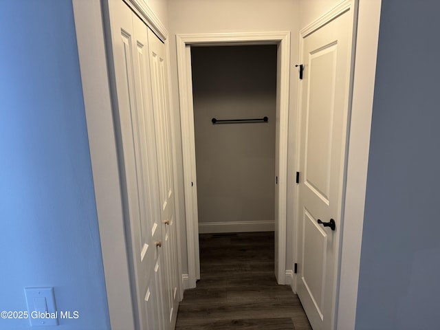 hallway with dark hardwood / wood-style flooring