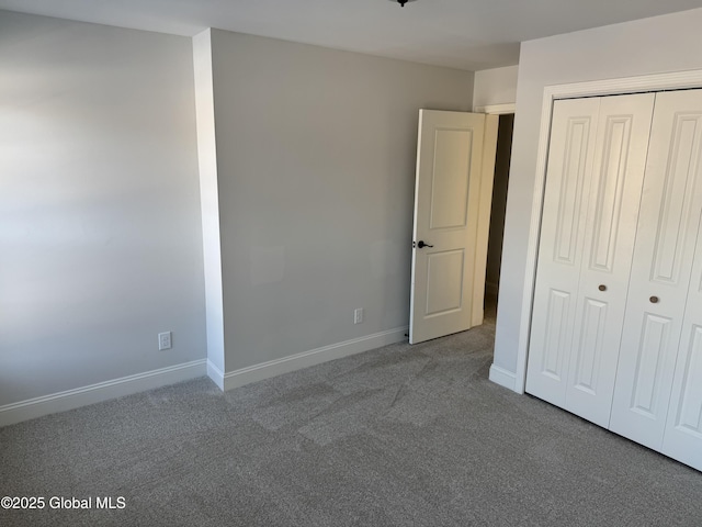 unfurnished bedroom with a closet and carpet