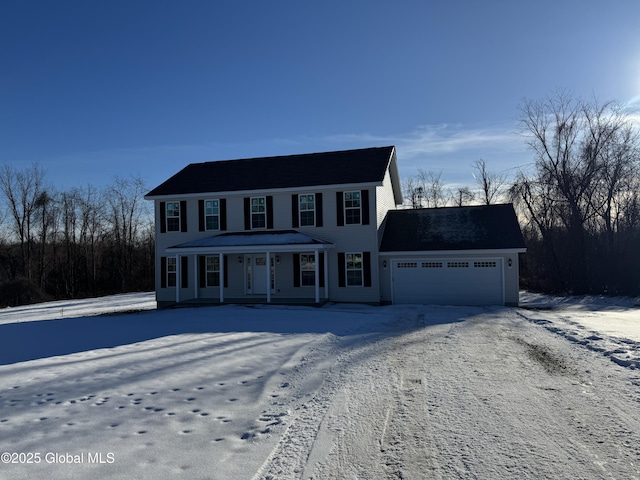 colonial house featuring a garage and a porch