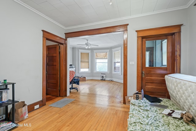 interior space with crown molding and light hardwood / wood-style floors