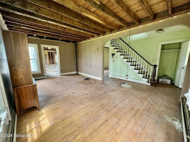 interior space featuring hardwood / wood-style flooring, a baseboard heating unit, and wood ceiling