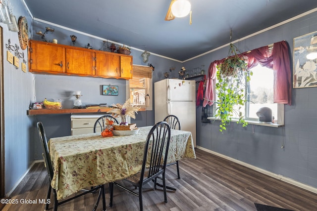 kitchen with white refrigerator, dark hardwood / wood-style floors, and crown molding