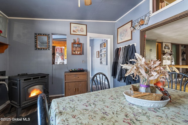 dining area featuring crown molding and a wood stove