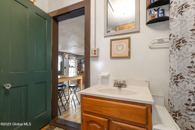 bathroom featuring hardwood / wood-style flooring, vanity, and a shower with curtain