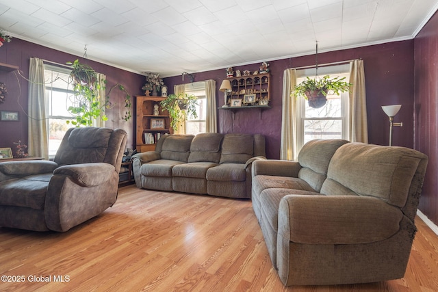 living room with ornamental molding, plenty of natural light, and hardwood / wood-style floors