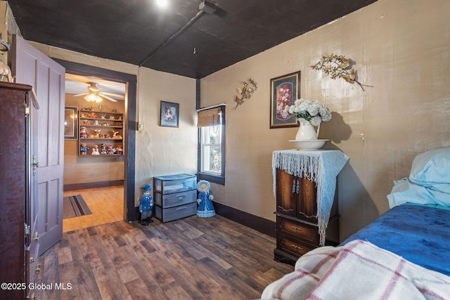 bedroom with dark hardwood / wood-style flooring