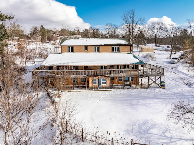 view of snow covered rear of property