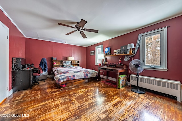 bedroom featuring crown molding, dark hardwood / wood-style floors, radiator, and ceiling fan