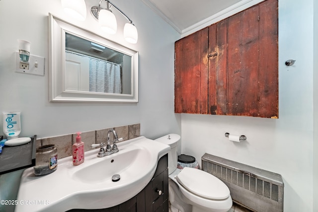 bathroom featuring crown molding, radiator heating unit, toilet, and vanity