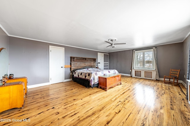 bedroom with ceiling fan, light hardwood / wood-style flooring, and ornamental molding