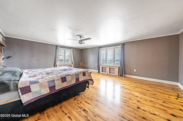 bedroom with crown molding and light hardwood / wood-style floors