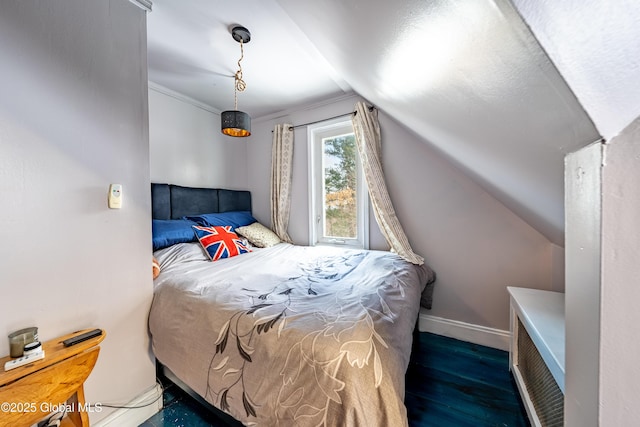 bedroom with dark hardwood / wood-style flooring and lofted ceiling