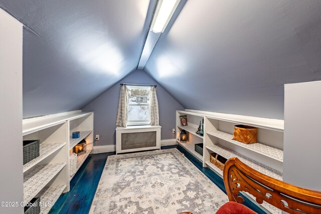 bonus room featuring dark hardwood / wood-style flooring and vaulted ceiling