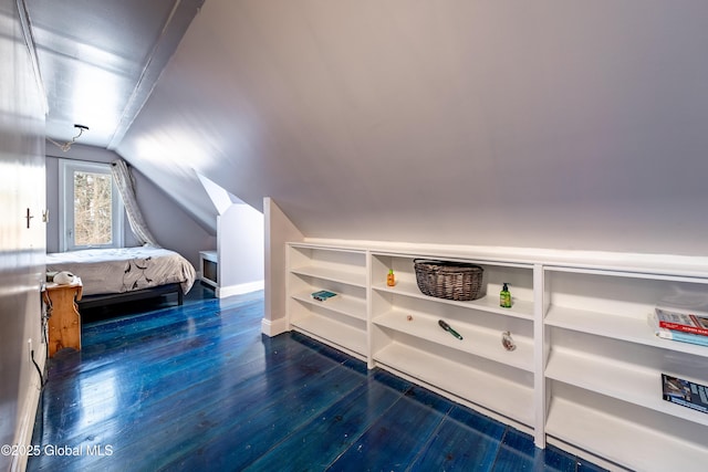 unfurnished bedroom featuring dark wood-type flooring and lofted ceiling