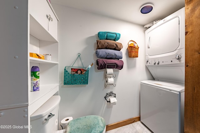 laundry area with stacked washer and dryer and light tile patterned flooring