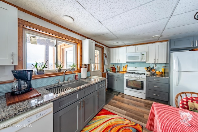 kitchen with white appliances, white cabinetry, sink, dark wood-type flooring, and gray cabinets