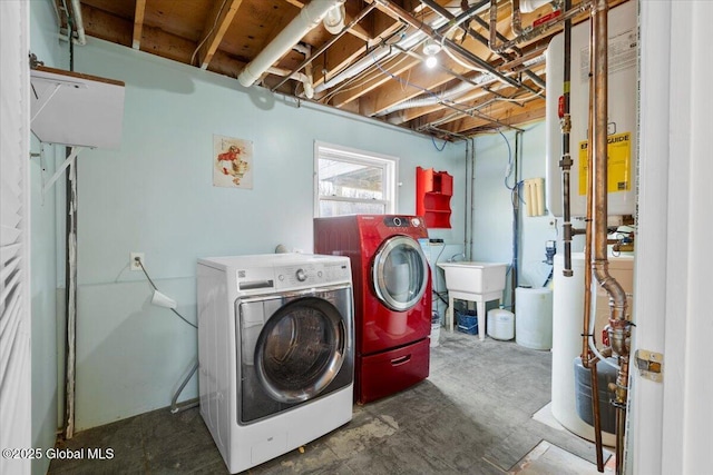 clothes washing area featuring sink and washer and dryer