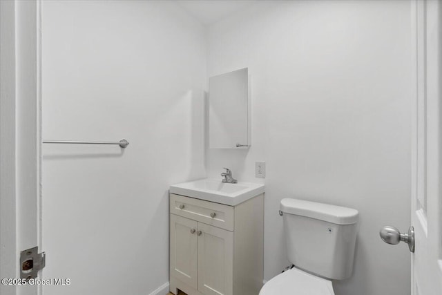 bathroom featuring toilet and vanity