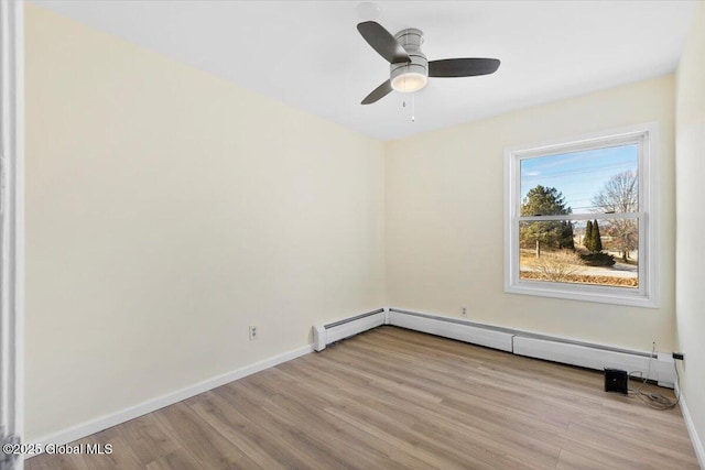 unfurnished room featuring a baseboard radiator, light wood-type flooring, and ceiling fan