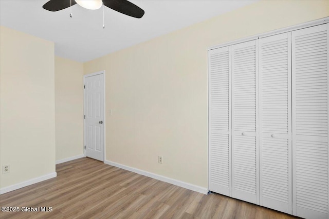 unfurnished bedroom featuring a closet, ceiling fan, and light wood-type flooring