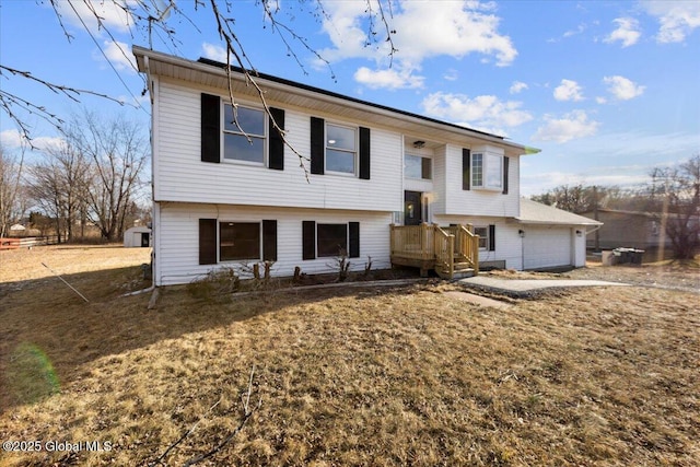 split foyer home featuring a garage and a front lawn