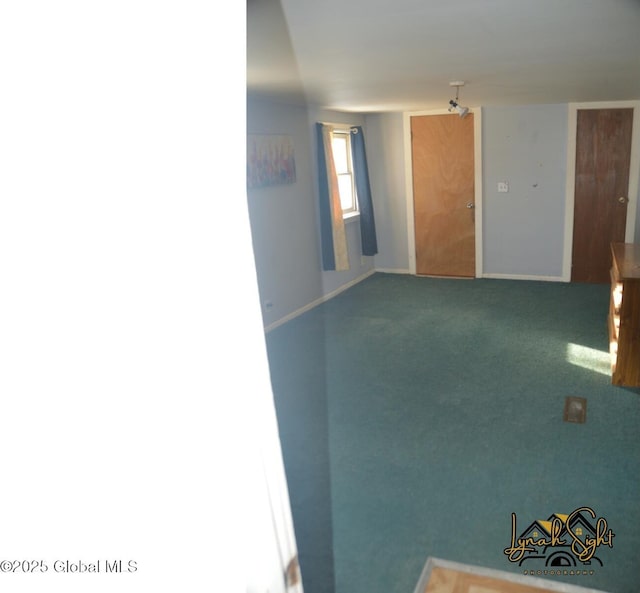 empty room with carpet floors and baseboards