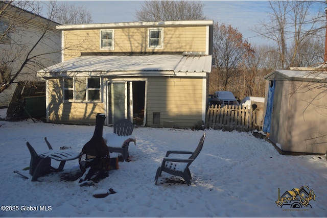 snow covered property featuring fence