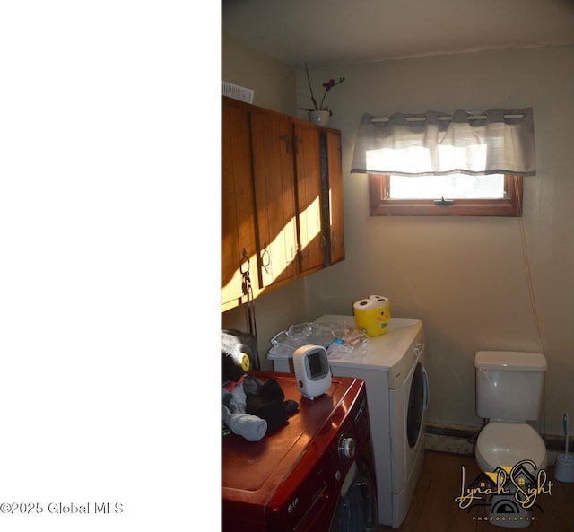washroom featuring washer and dryer, visible vents, and laundry area