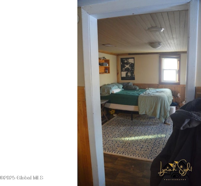 bedroom with wooden ceiling and wood finished floors