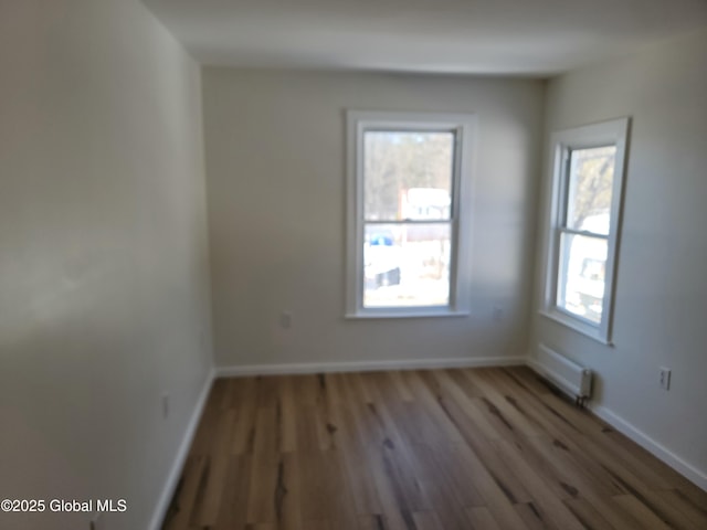 spare room with hardwood / wood-style floors