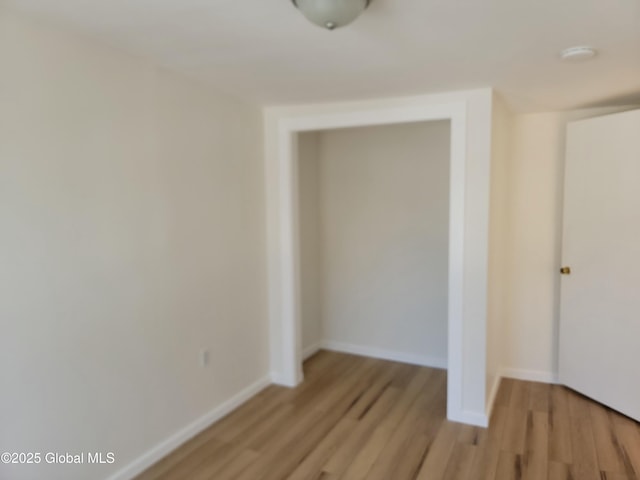 spare room with light hardwood / wood-style flooring