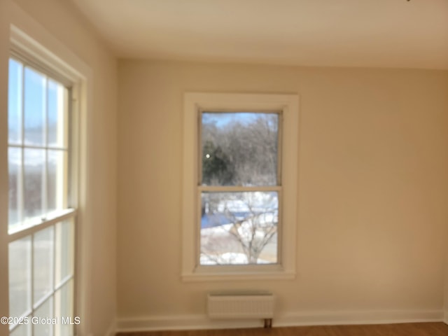 spare room featuring radiator