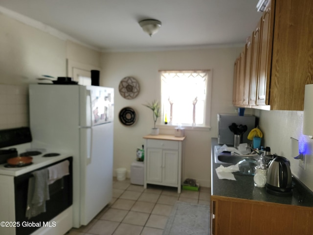 kitchen featuring range with electric cooktop, crown molding, and light tile patterned flooring