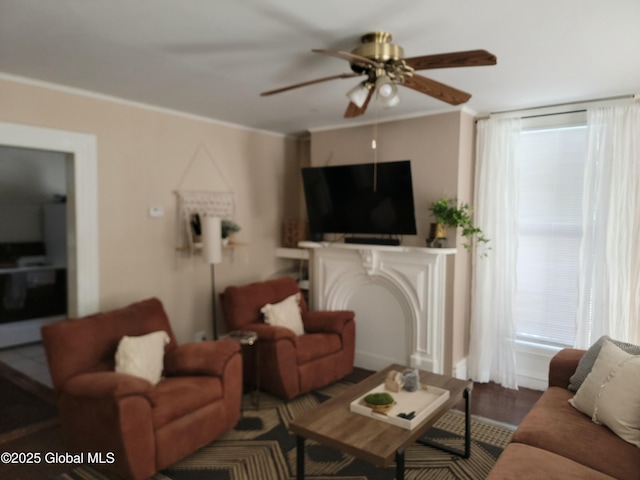 living room featuring crown molding and ceiling fan