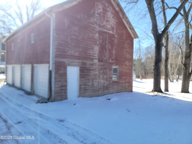 view of snow covered exterior featuring an outdoor structure