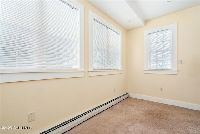 carpeted spare room with baseboard heating