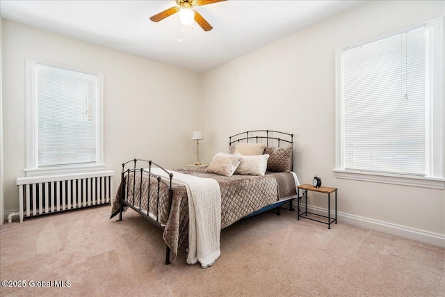 carpeted bedroom featuring ceiling fan and radiator heating unit