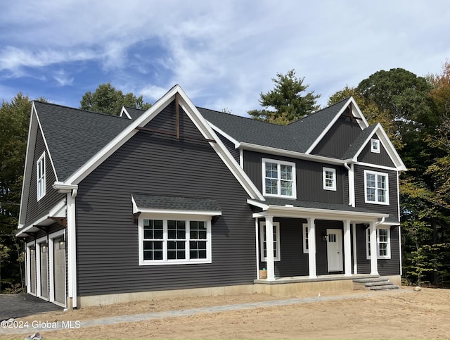 view of front of house with a porch and a garage