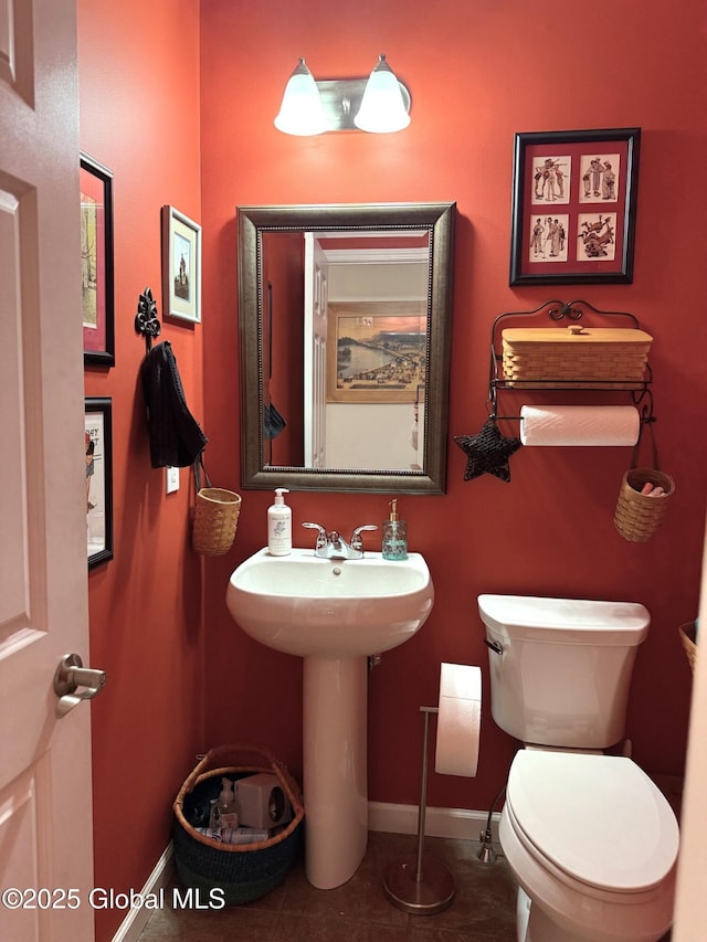 bathroom featuring sink, toilet, and tile patterned floors