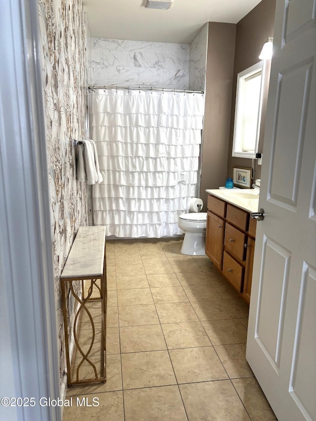 bathroom featuring curtained shower, tile patterned floors, toilet, and vanity